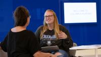 Columbia Nursing student sitting and speaking with professor.